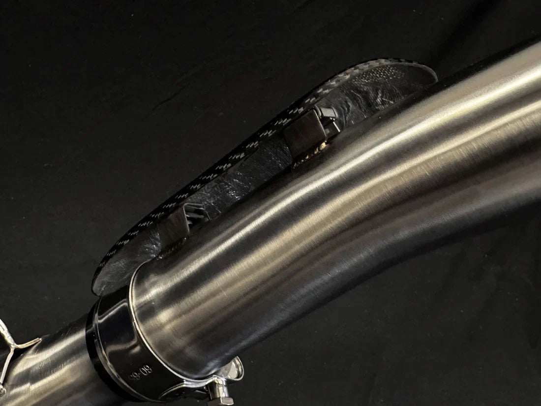 Triumph Tiger 900 exhaust system with carbon fiber cover, designed by Bill's Exhausts for enhanced performance and style.