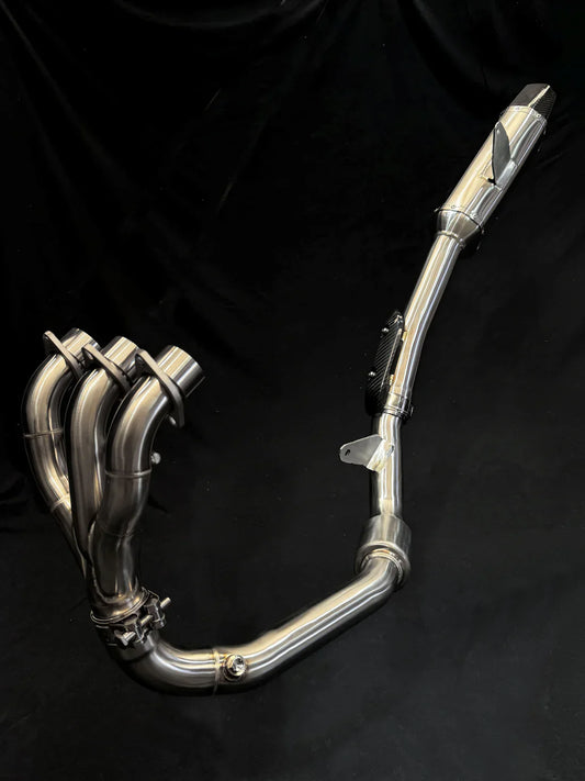 Stainless steel Triumph Tiger 850-900 full exhaust system by Bill's Exhausts, shown installed on a motorcycle.