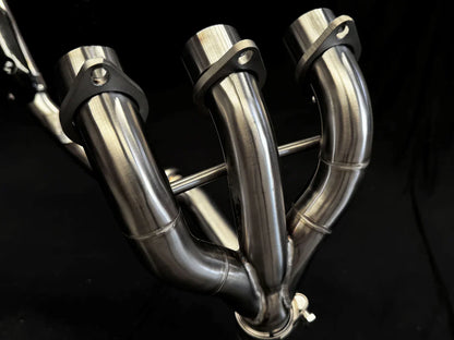 Stainless steel headers for Triumph Tiger 850-900 full exhaust system by Bill's Exhausts, showing polished metal pipes and fittings.