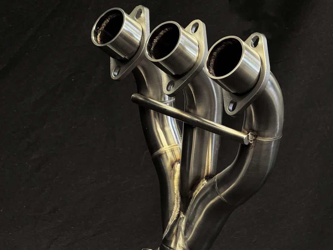 Stainless steel headers for Triumph Tiger 850-900 full exhaust system by Bill's Exhausts, showing polished metal pipes.