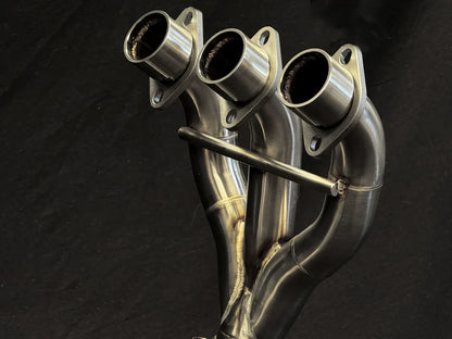 Stainless steel headers for Triumph Tiger 850-900 full exhaust system by Bill's Exhausts, showing polished metal pipes.