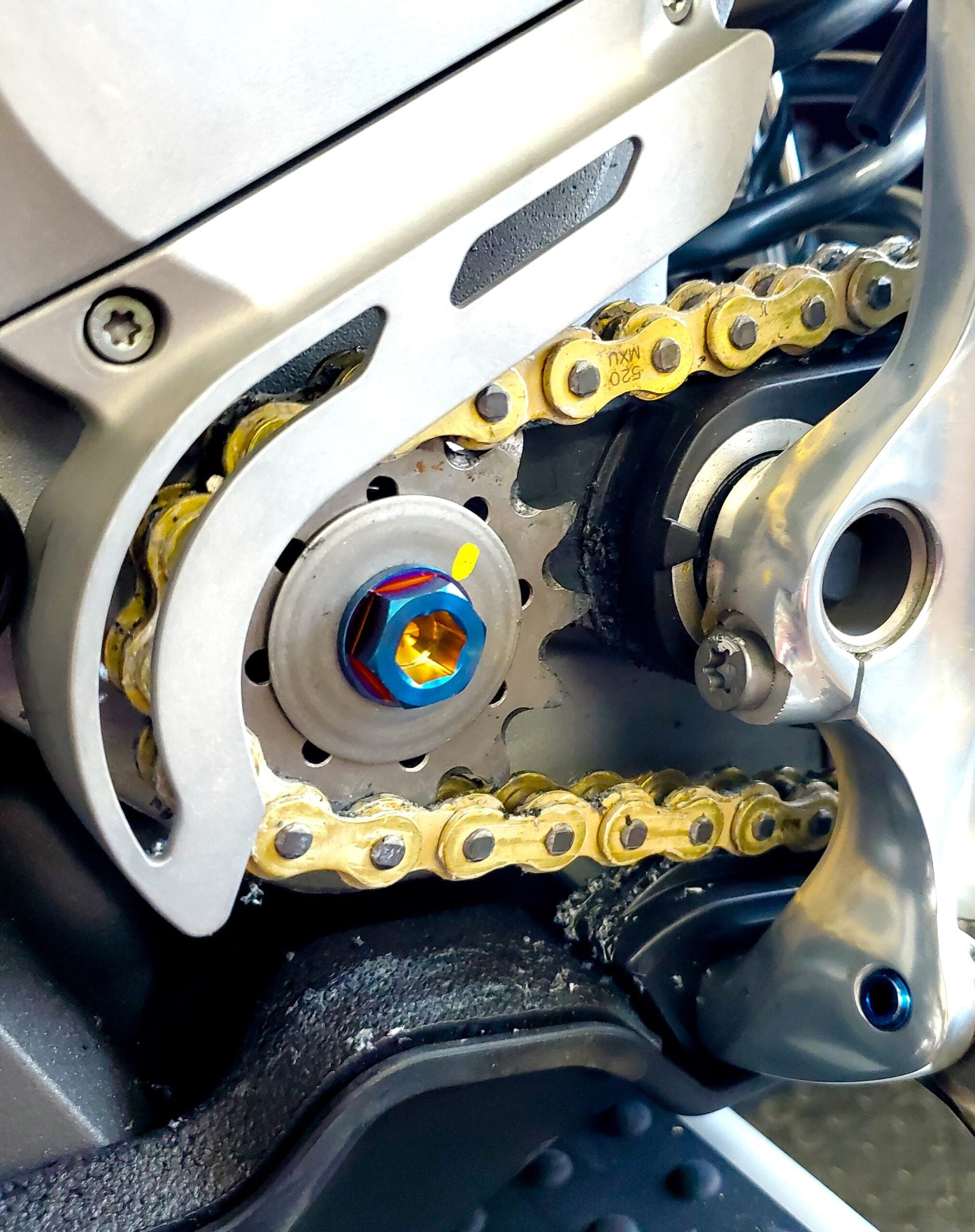 Warp9Racing Stark Varg Titanium Counter Shaft Replacement Bolt installed on electric bike motor for durable performance.