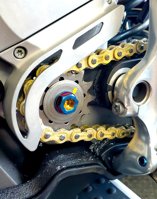 Warp9Racing Stark Varg Titanium Counter Shaft Replacement Bolt installed on electric bike motor for durable performance.