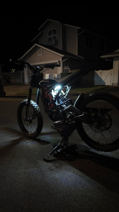 White Surron underglow rear kit from Project9, featuring LED lights installed on the back of the electric dirt bike.