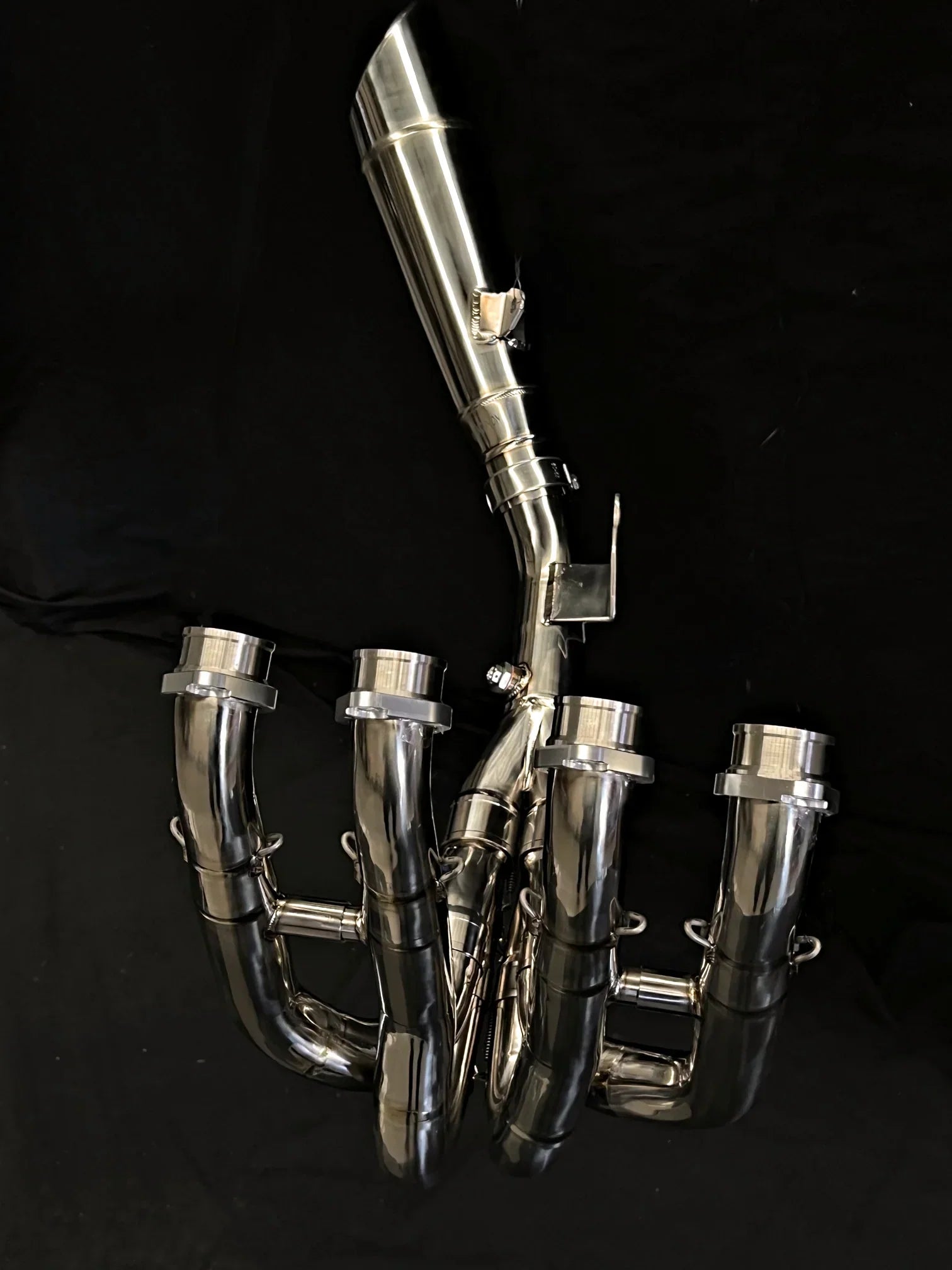 Polished titanium exhaust system for Kawasaki Ninja ZH2, open box from Bill's Exhausts, showcasing the sleek, shiny metallic finish.