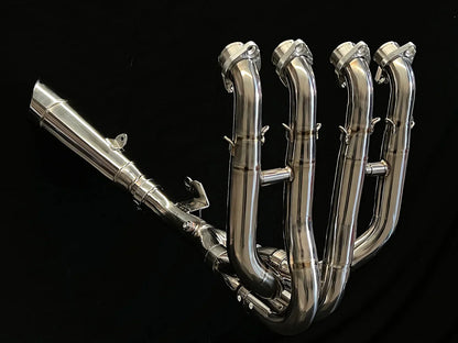 Polished titanium exhaust system for Kawasaki Ninja ZH2, open box by Bill's Exhausts, showcasing sleek metal finish and exhaust pipes.