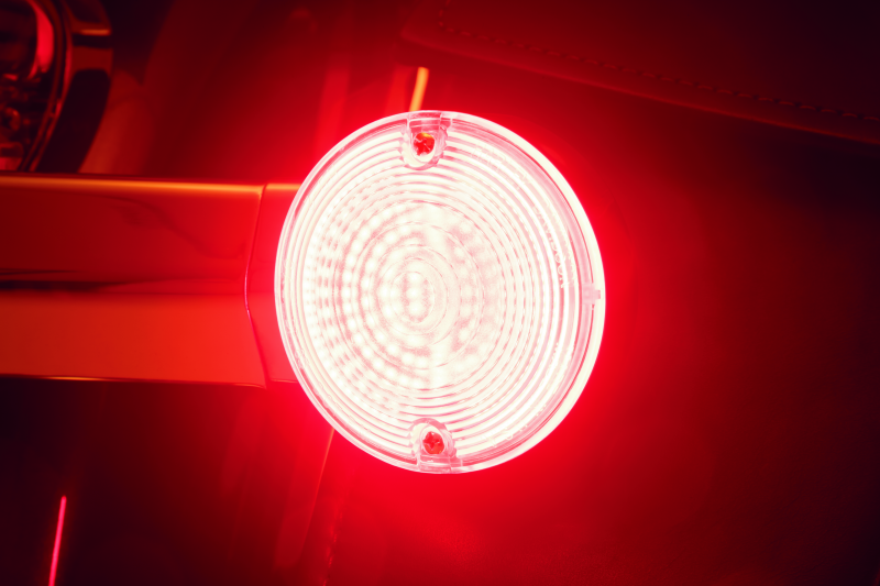 Kuryakyn Luminez LED rear turn signal insert for Harley-Davidson, red flat style 1156 bulb, with clear lens and compact design.