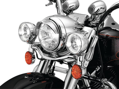 Kuryakyn 7-inch headlight visor for Harley-Davidson motorcycles, black metal shield with mounting hardware visible
