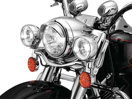 Kuryakyn 7-inch headlight visor for Harley-Davidson motorcycles, black metal shield with mounting hardware visible