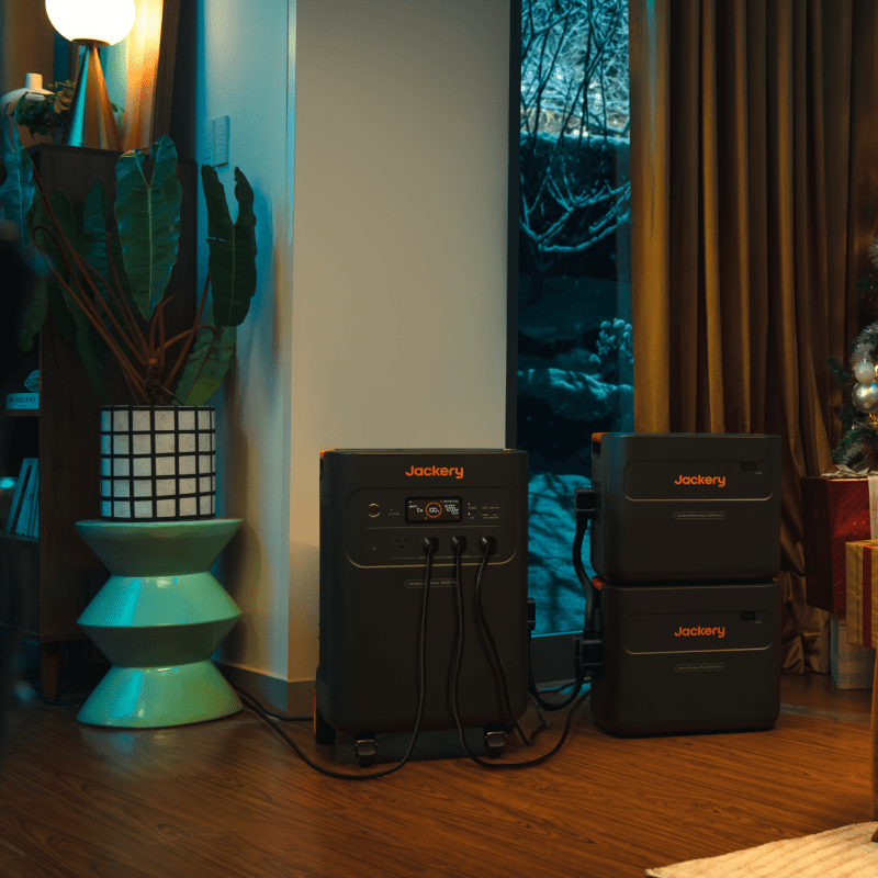 Jackery Battery Pack 5000 Plus attached to a handbag, portable power bank with compact design and black finish.
