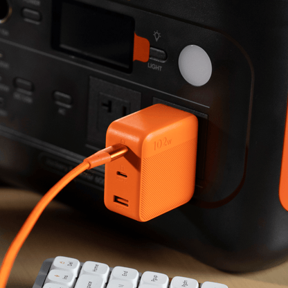 Jackery 102W GaN 3-port fast charger with compact black design and multiple USB charging ports