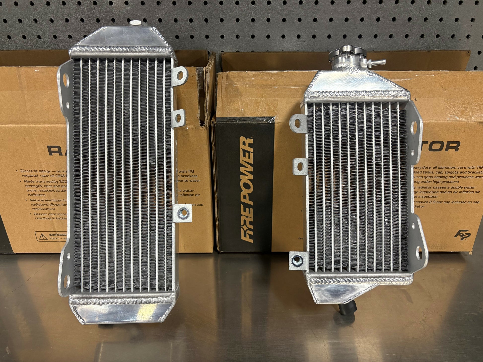 FIRE POWER TRS-R-140L radiator for Kawasaki motorcycle, high-performance aluminum cooling solution with visible fins and mounting points.