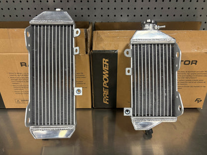 FIRE POWER TRS-R-140L radiator for Kawasaki motorcycle, high-performance aluminum cooling solution with visible fins and mounting points.