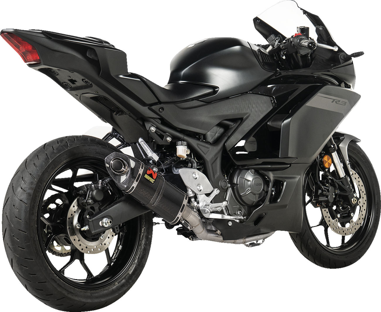 AKRAPOVIC Racing Line exhaust system with carbon fiber finish for Yamaha R3 and MT-03 motorcycle, showcasing sleek design and branding.