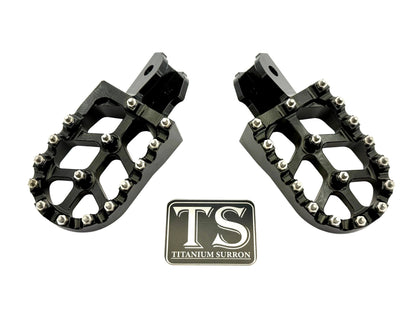 Anodized aluminum 6061 TS foot pegs for Surron e-moto and similar electric bikes, featuring durable titanium Surron branding.