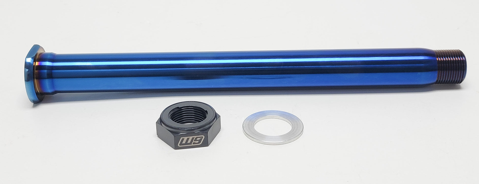 Warp9Racing titanium rear axle for KTM bikes, showcasing a lightweight, durable motorcycle axle with precise machining and a polished finish.