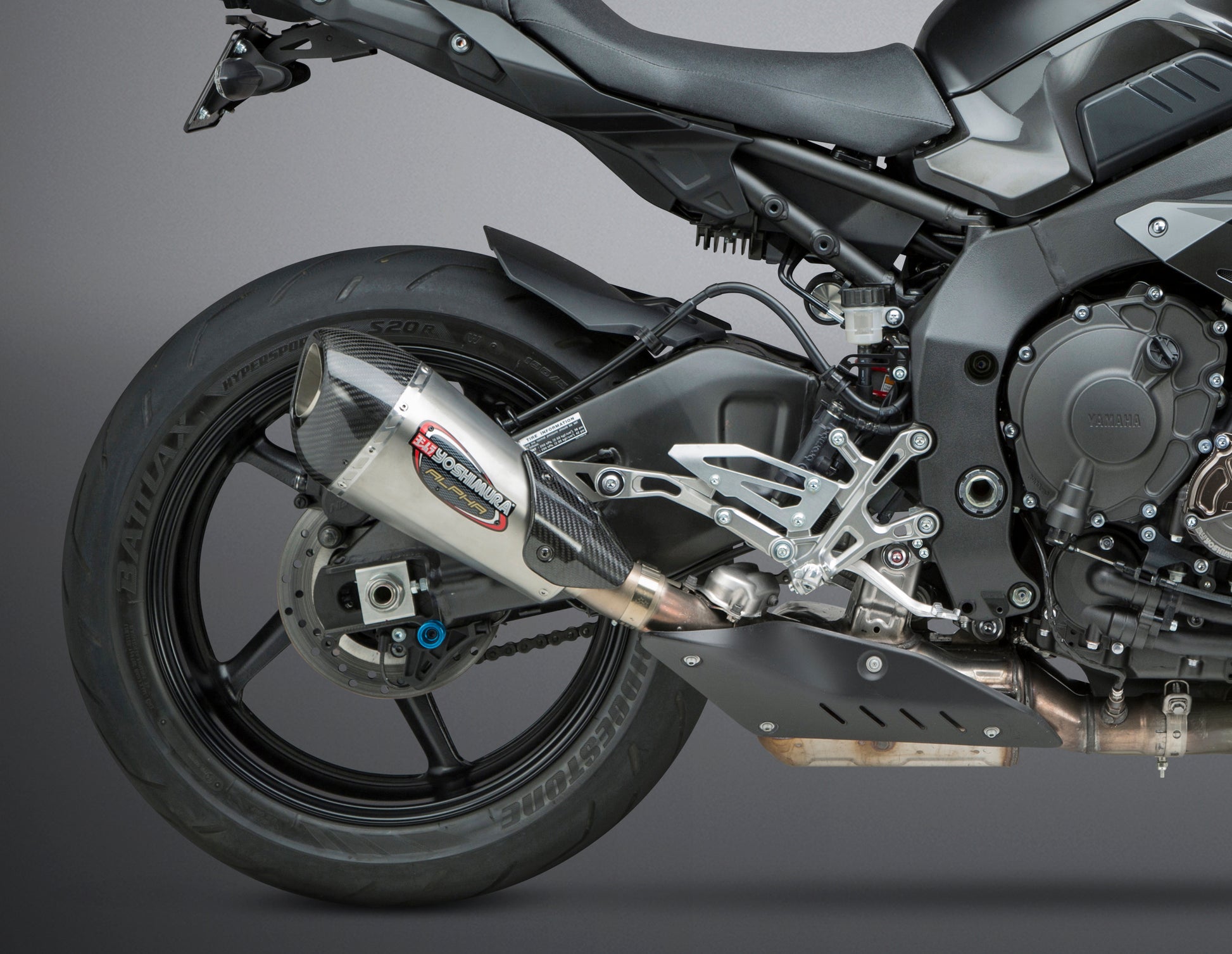 YOSHIMURA Street Alpha T Slip-On exhaust with stainless steel and carbon fiber end cap for motorcycle performance and sleek design