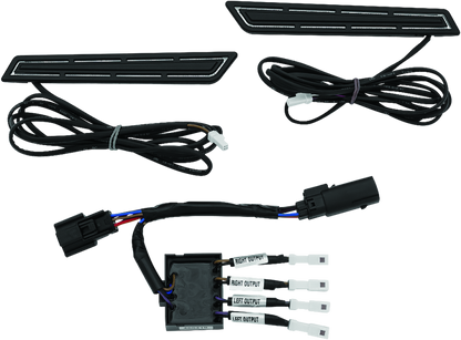 Kuryakyn LED saddlebag hinge accents for Harley Davidson with bright red run, brake, and turn signal lights on a motorcycle.