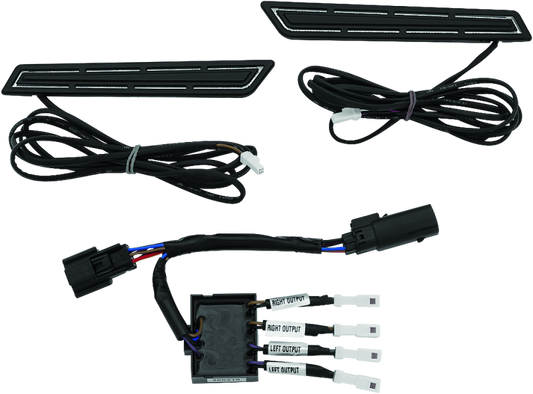 Kuryakyn LED saddlebag hinge accents for Harley Davidson with bright red run, brake, and turn signal lights on a motorcycle.