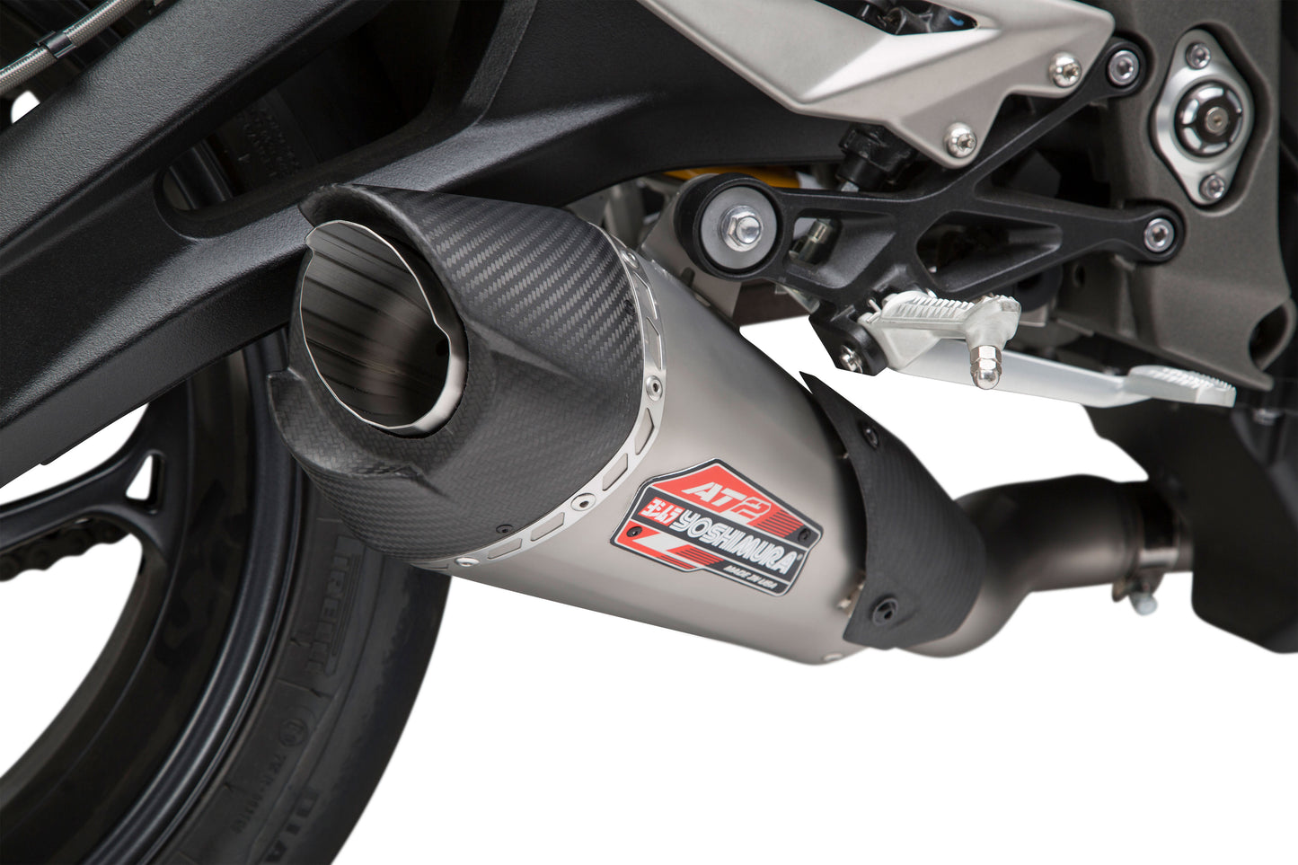 YOSHIMURA Street AT2 Works slip-on exhaust with carbon fiber end cap for motorcycle, showing sleek design and branding.