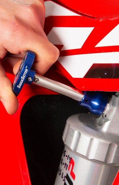 Motion Pro shock setter tool 08-0756 for motorcycle suspension adjustment, shown with metal tool and motorcycle suspension components.