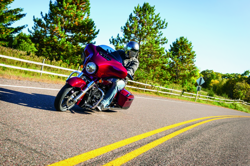 Kuryakyn Smooth Windshield Trim for Harley Davidson Touring motorcycles, showing sleek chrome design on the windshield edge.
