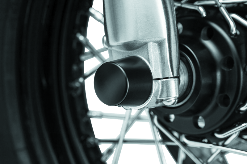 Kuryakyn satin black front axle nut caps for Harley Davidson touring models, fitting securely over the axle nut.