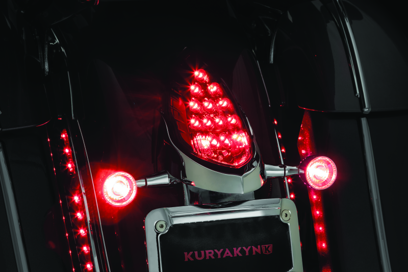 Kuryakyn custom rear turn signal and license plate mount for Indian motorcycles, shown on a black motorcycle with clear signals