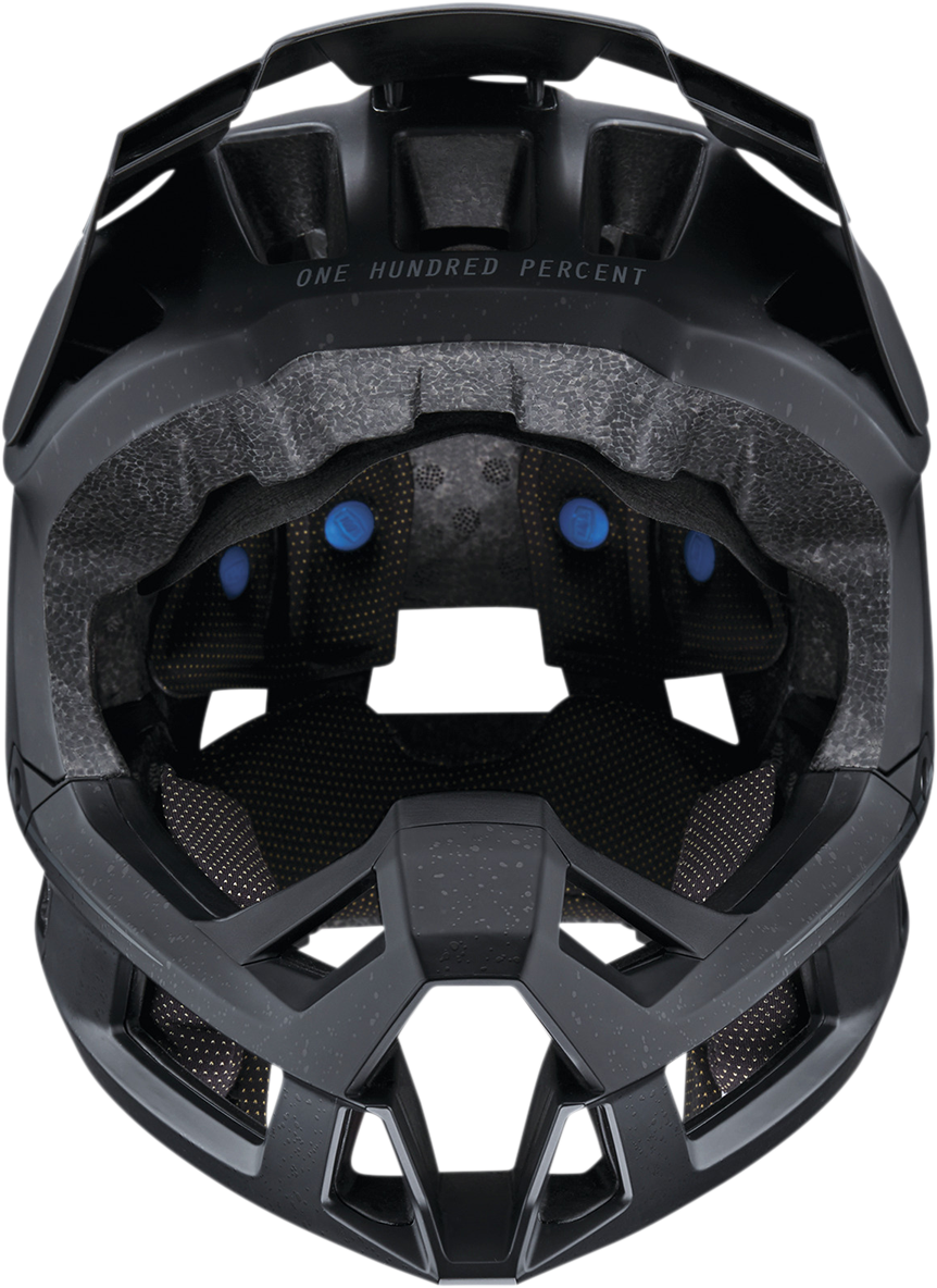 Black 100% Trajecta bicycle helmet with Fidlock buckle, medium size, designed for safe and comfortable cycling.