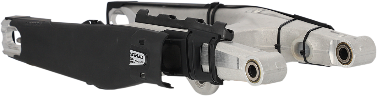 Black ACERBIS Swing Arm Guard for motorcycle, designed to protect the swing arm from dirt and debris.