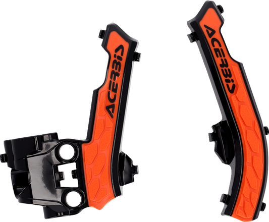 Acerbis X-Grip motorcycle frame guards in black and orange attached to a bike frame, providing protection and style.