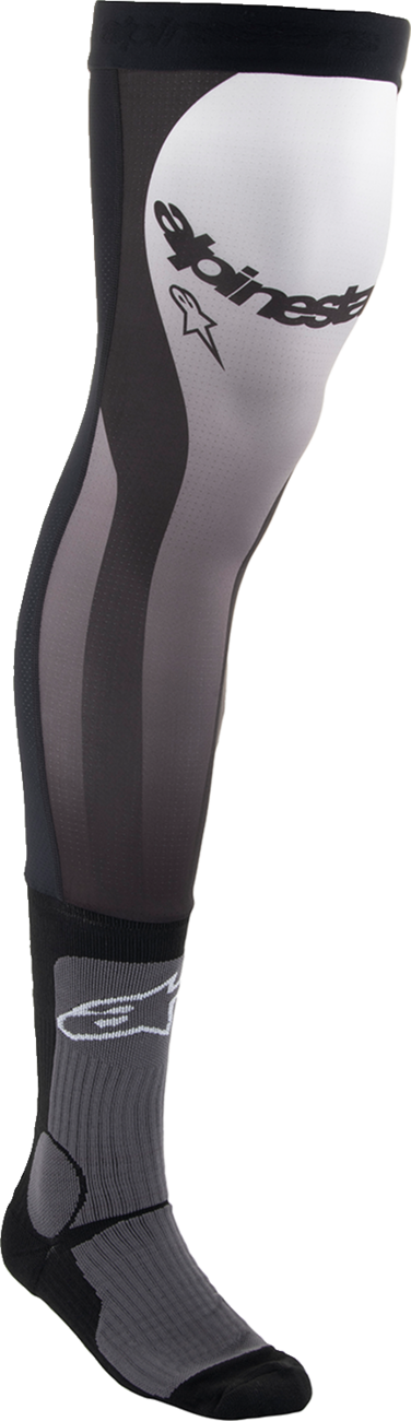 Alpinestars knee brace socks in black and white, large/XL size, designed for athletic support and comfort.