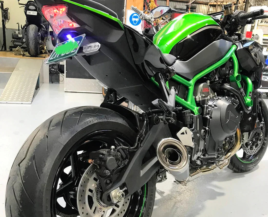 Polished titanium Vandemon exhaust system for Ninja ZH2 2020-25, installed on a Kawasaki motorcycle, showcasing sleek, high-performance design.