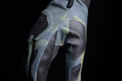 Open box green ICON Hooligan Battlescar gloves in medium size, showcasing rugged design and textured material from Bill's Exhausts.