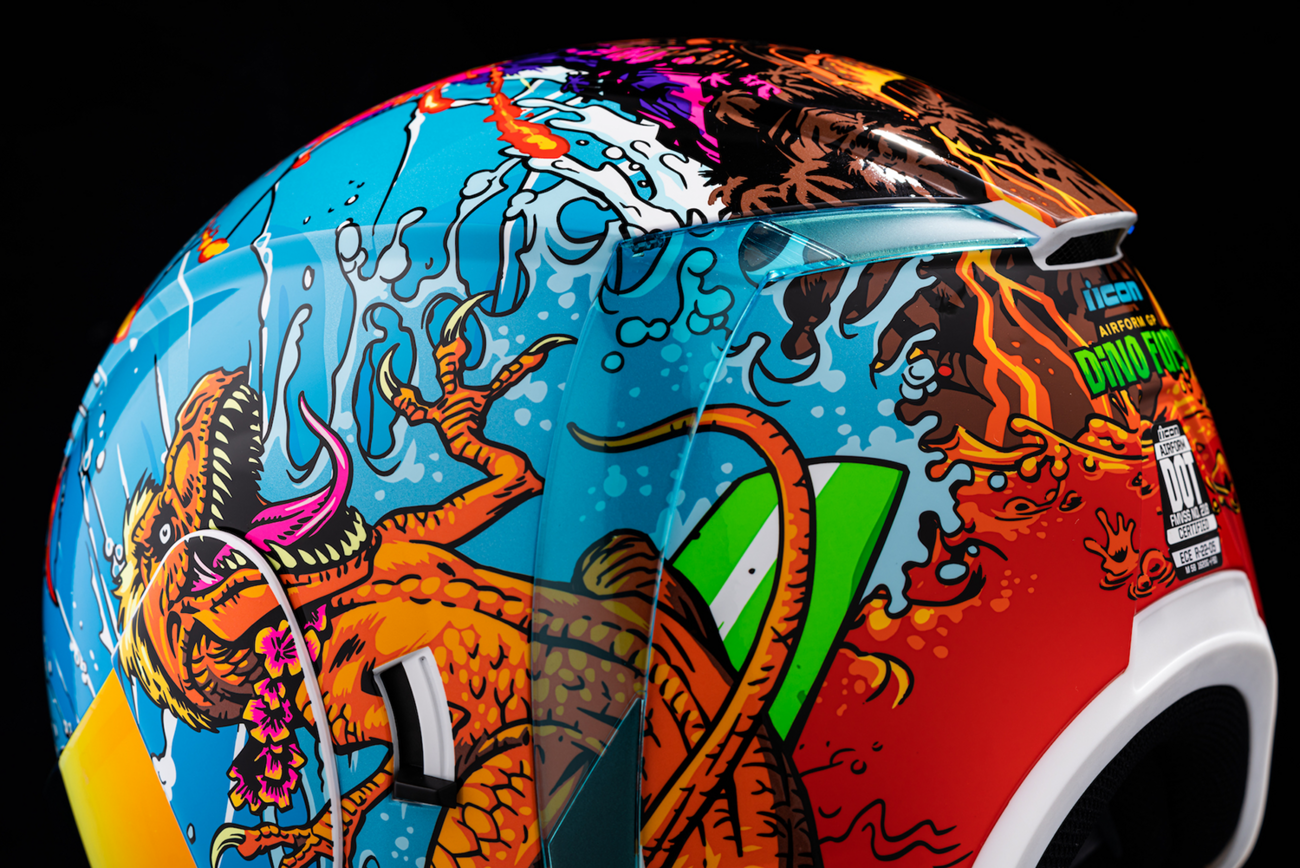 Large ICON Airform Dino Fury helmet featuring vibrant dinosaur-themed design, made by Bill's Exhausts, for motorcycle safety.