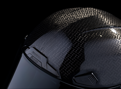 Black ICON Airframe Pro™ helmet with carbon 4Tress design, XS size, shown on a plain background, highlighting its sleek style.
