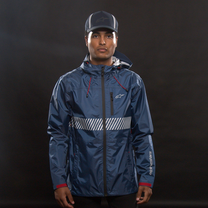 Alpinestars Fusion Rain Jacket in navy, medium size, shown on a hanger with waterproof fabric and reflective details.