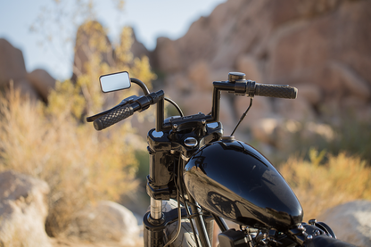 Black BILTWELL rectangular clamp-on mirror for motorcycles, 1-inch size, mounted on handlebars for clear rear visibility.