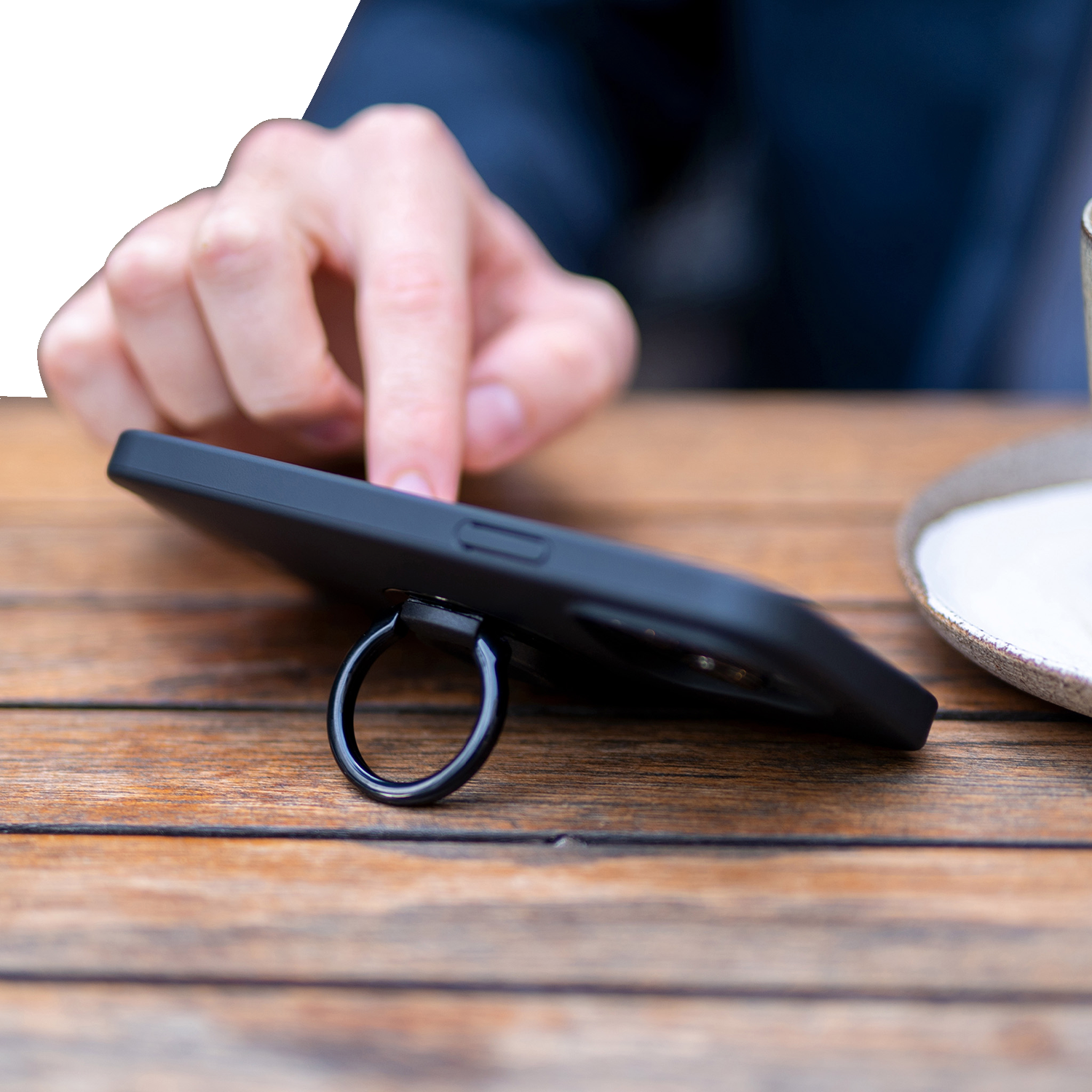 Black SP CONNECT phone mount ring attached to a device, designed for secure smartphone holding and easy access.