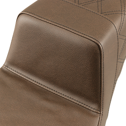 Brown SADDLEMEN Step-Up Seat with rear lattice stitch, designed for motorcycle comfort and style, by Bill's Exhausts.