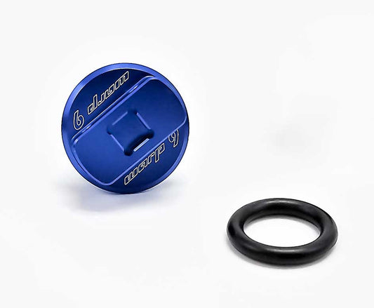 Blue oil filler cap from Warp9Racing, designed for automotive engines, featuring a sleek, durable metal construction.
