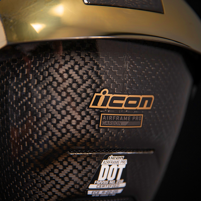 Bill's Exhausts ICON Airframe Pro™ helmet in carbon with gold finish, small size, showcasing sleek design and aerodynamic features.