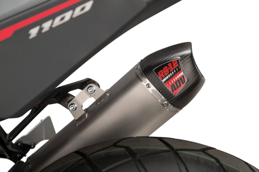 YOSHIMURA RS-12 Slip-On Exhaust for off-road vehicles, silver finish, mounted on a dirt bike with visible mounting hardware.