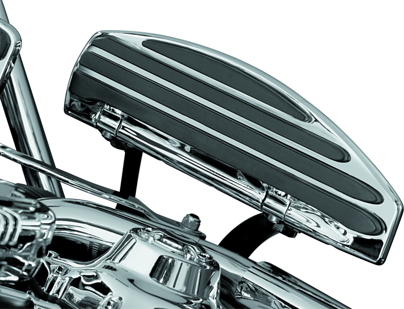 Kuryakyn running board extensions installed on a Harley-Davidson Touring motorcycle, showing the chrome finish and mounting details.