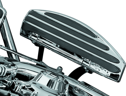Kuryakyn running board extensions installed on a Harley-Davidson Touring motorcycle, showing the chrome finish and mounting details.
