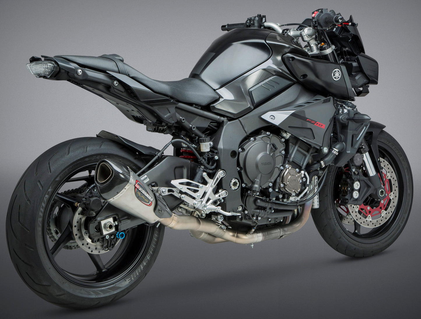YOSHIMURA Race Alpha T 3/4 slip-on exhaust with carbon fiber end cap, featuring sleek metallic finish and compact design