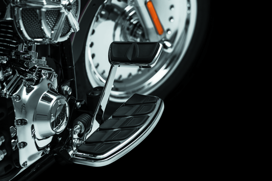 Kuryakyn Kinetic brake pedal pad in chrome for Harley Davidson Touring models, showing the textured surface and sleek finish