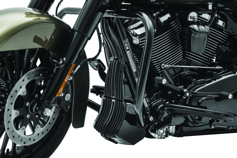 Black Kuryakyn oil cooler cover for Harley Davidson Touring models, part #6418, shown installed on motorcycle engine area.