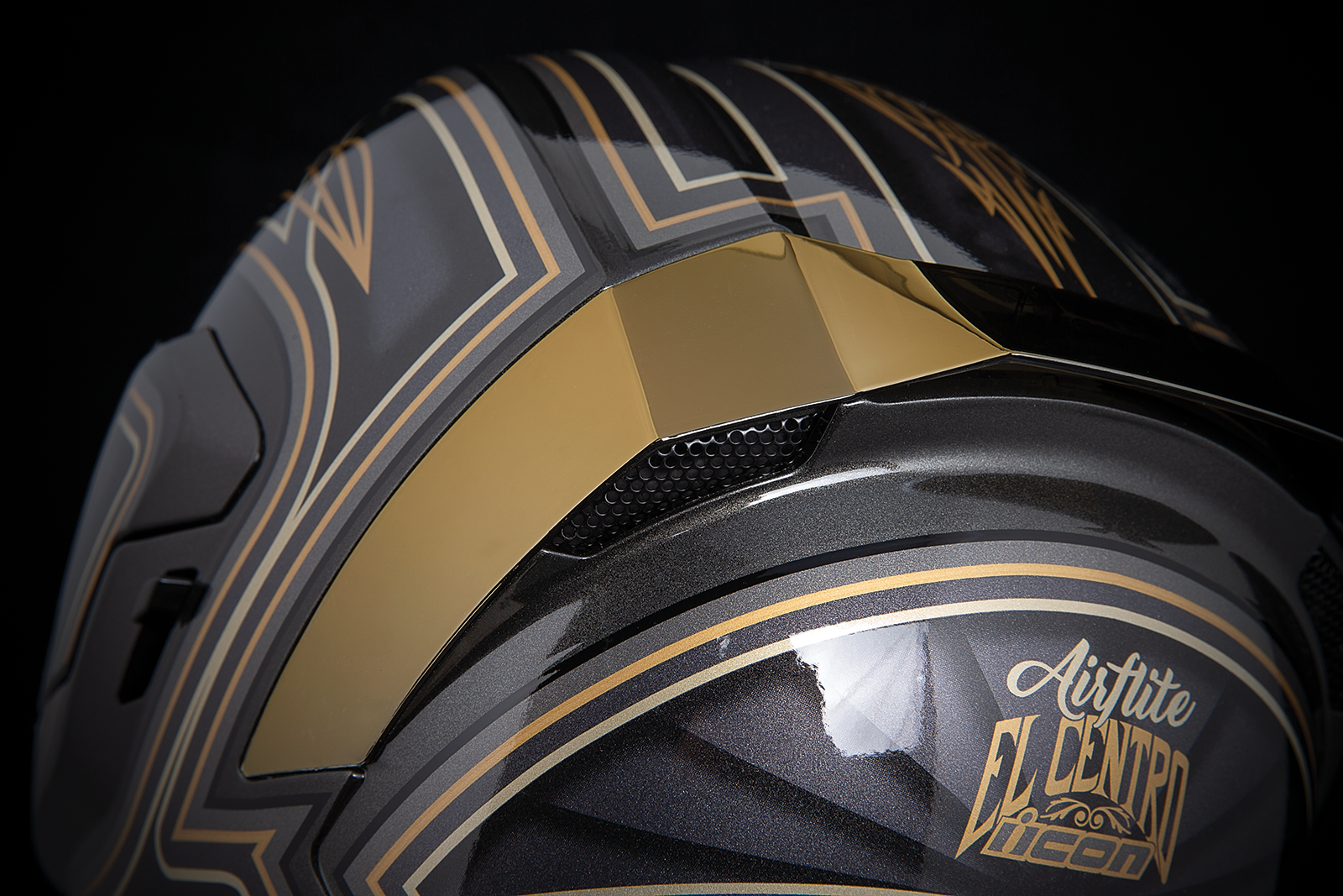 Black ICON Airflite™ helmet in medium size featuring sleek design and aerodynamic shape, positioned on a reflective surface.