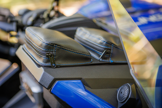Bill's Exhausts SHOW CHROME Kaliber Dash Pouch in black with blue stitching for engine storage, shown on a vehicle dashboard.
